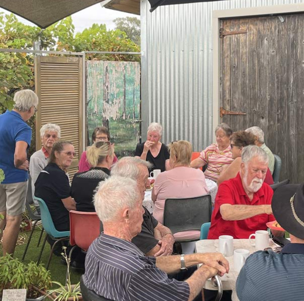 Lockington Cuppa Connections held in 2024 - group of people seated outside of garage doors