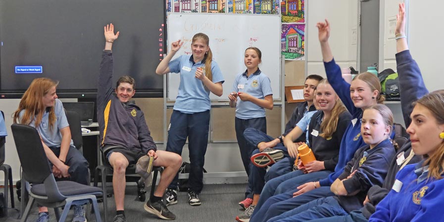High school students raising their hands