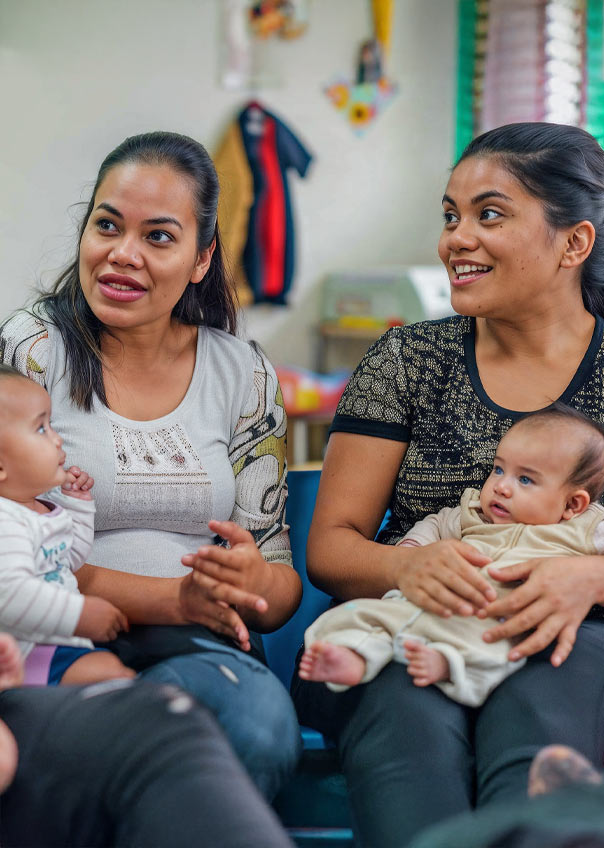 Two Mothers with babies on their laps