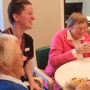 Student Morgan entertains the ladies at lunch.