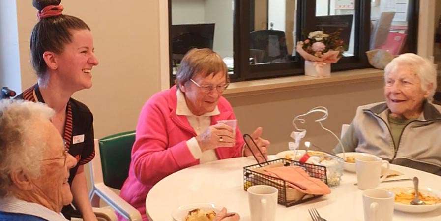 Student Morgan entertains the ladies at lunch.
