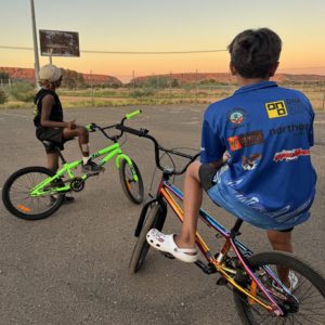 Two boys on BMX bikes at sunset
