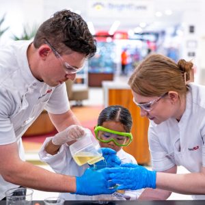 Pharmacists with a child doing experiments