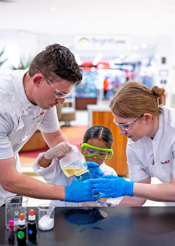 Pharmacists with a child doing experiments