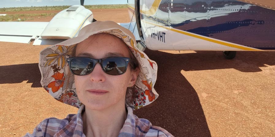 Cara Sheppard in front of a small aircraft