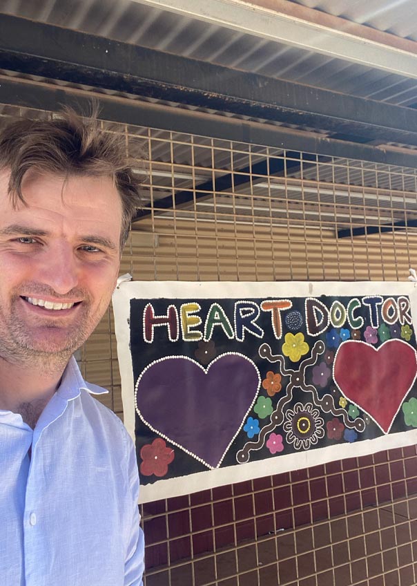 Angus on outreach at Kintore clinic with their ‘Heart Doctor’ sign.