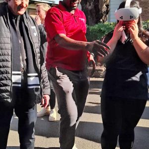 Image caption: A student explores rural practice through a virtual reality headset at the 2025 Western Sydney University Open Day in Parramatta, as the University Chancellor watches on. Photo credit: Bathurst Rural Clinical School