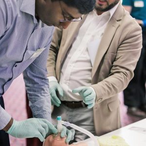 Medical student practicing procedure on training baby