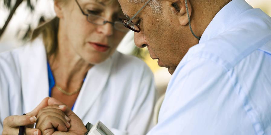 Doctor looking at patients arm