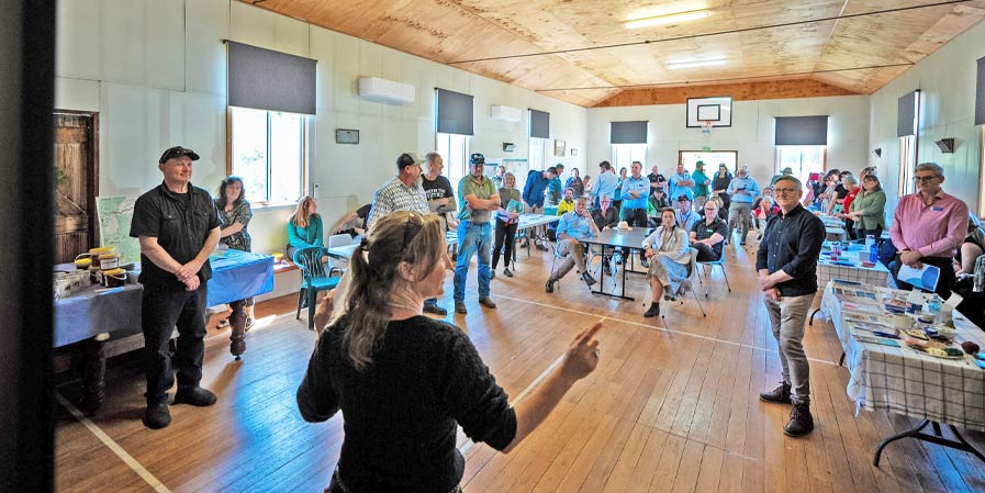Community gathering in hall Isaac Carne
