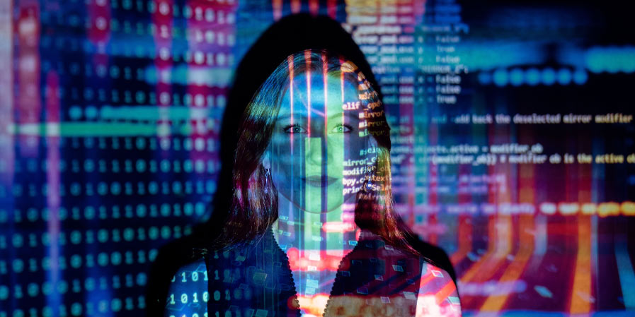 Woman with computer code projected over her face and wall