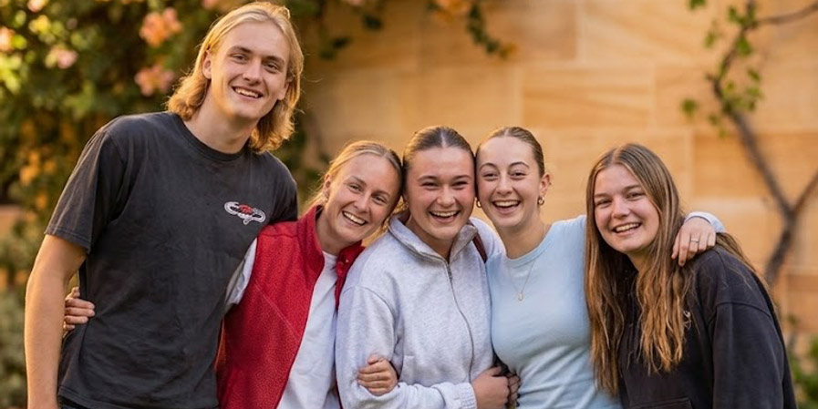 Five medical student volunteers posing together for photo