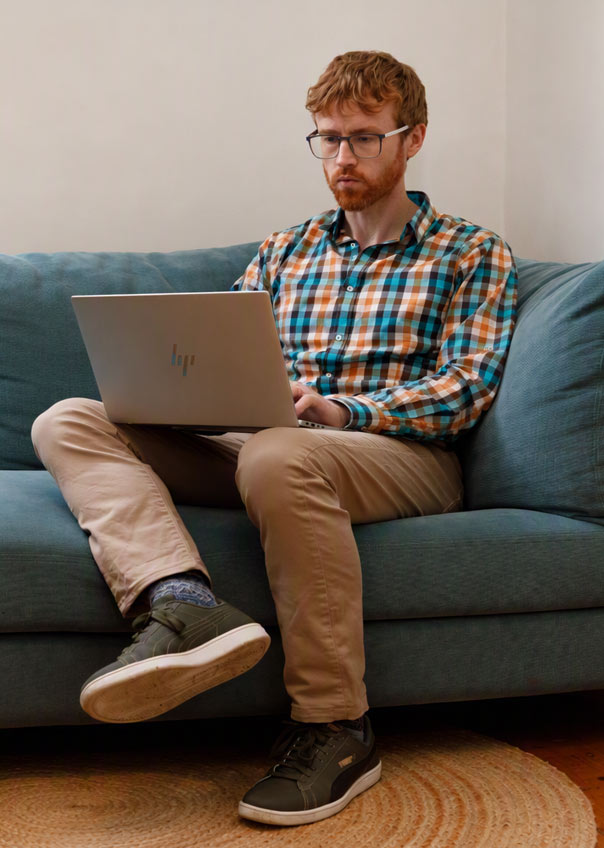 Man using a laptop on a lounge